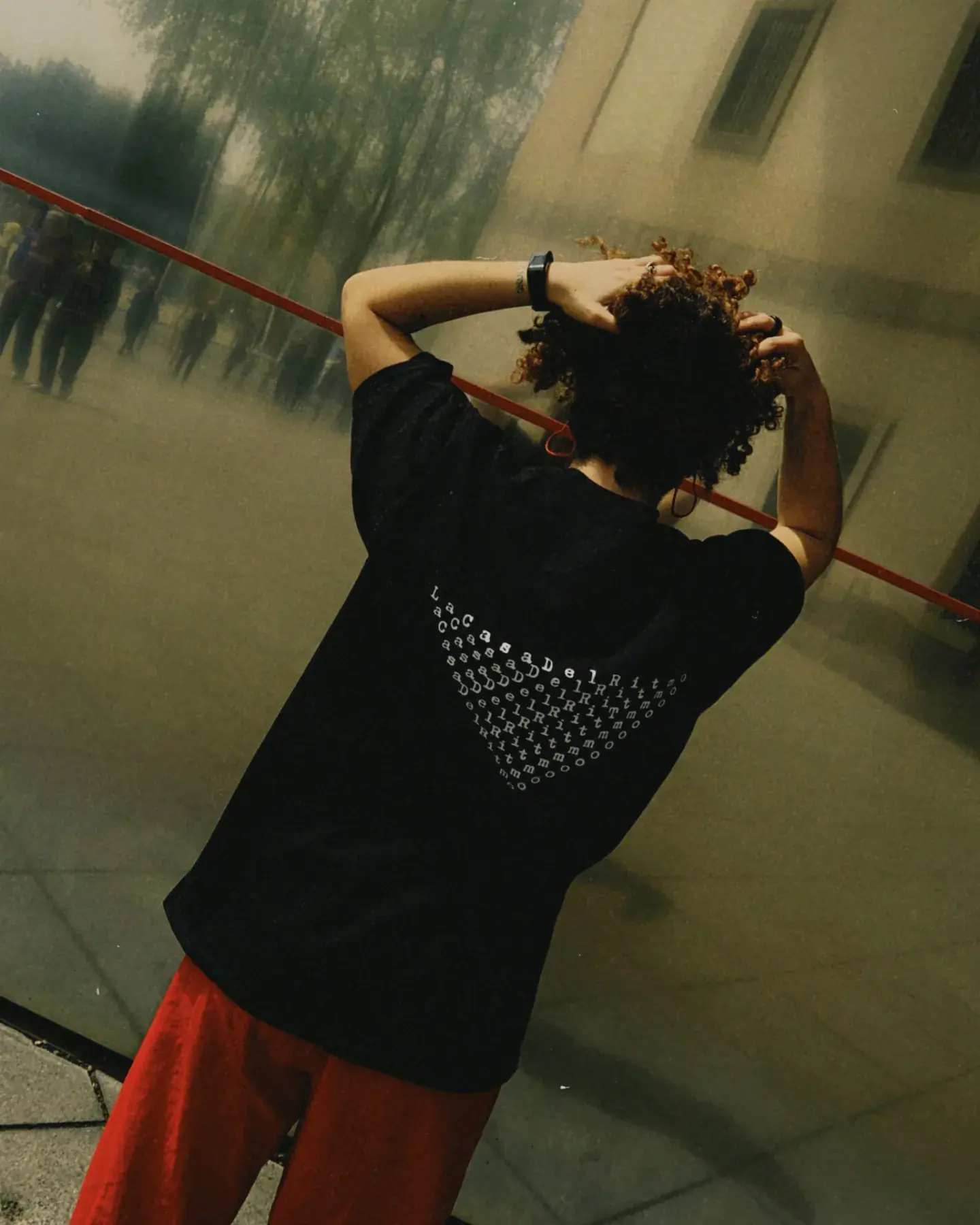 RITMO T-Shirt by CRINI and Supermaier, back print worn outdoors